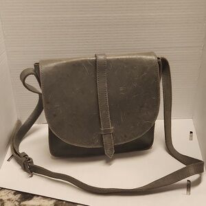 Fashionable leather purse grayish crossbody has scratches